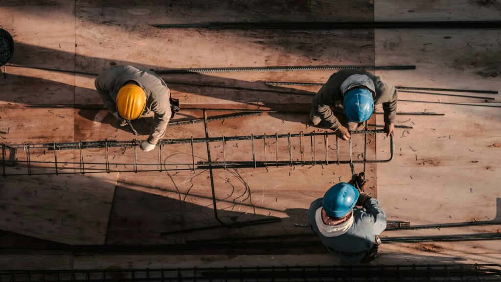 Workers using a wind and watertight container while building a structure