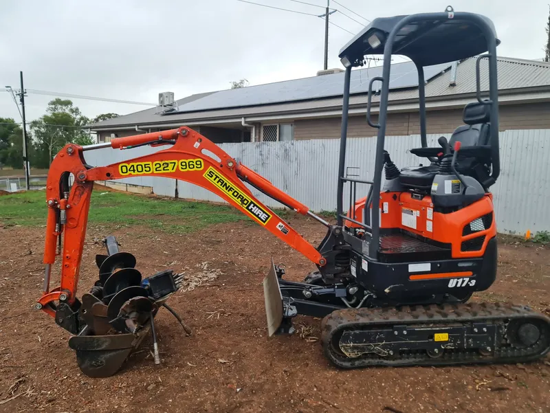 Excavator preparing the ground surface for a shipping containers
